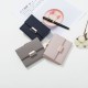 Prettyzys' popular Korean-style short, tri-folded women's wallet, a fresh, PU, ​​plaid, and zippered student wallet.
