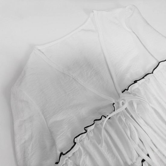 Elegant long-sleeved top, blouse. Loose-fitting V-neck, ruffled hem, contrasting lace-up design for a slimming, versatile shirt.